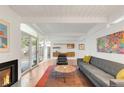 Bright living room with a fireplace, sliding glass doors to the backyard, and cozy seating area at 1338 S Fairfax St, Denver, CO 80222