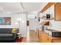 Inviting living room features hardwood floors, stylish furniture, and open shelving for a modern feel at 1338 S Fairfax St, Denver, CO 80222