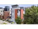 Three story grey home with an orange section next to the front door, with parking in the back at 2922 W 26Th Ave # 1, Denver, CO 80211