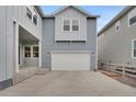 Spacious three car garage with a bright white door on a home with blue siding at 9396 Bear River St, Littleton, CO 80125