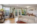 Bright living room featuring hardwood floors, plants, and a balcony access at 1203 6Th St # 1203, Golden, CO 80403
