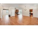 Open-concept living room with hardwood floors, fireplace, and access to the kitchen at 22898 Addington Pl, Parker, CO 80138