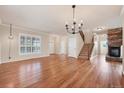 Spacious living room boasting hardwood floors, a stone fireplace, and a staircase at 22898 Addington Pl, Parker, CO 80138