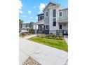 Charming home with a well-maintained lawn, and black metal fence with a view of the neighborhood at 1954 S Poplar Ct, Denver, CO 80224