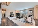 Cozy living room with a fireplace, lots of windows, and comfortable seating at 22991 Hope Dale Ave, Parker, CO 80138