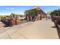 Brick home with a gated driveway and mature landscaping, offering curb appeal at 5960 Glencoe St, Commerce City, CO 80022