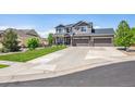 Two-story house with a landscaped yard and a long driveway at 8939 Devinney Ct, Arvada, CO 80005