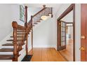 Home entryway with hardwood floors, ornate staircase, traditional moldings, and warm lighting at 1352 N Downing St, Denver, CO 80218