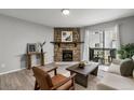 Cozy living room features a stone fireplace, comfortable seating and access to the outdoor balcony at 13333 E Asbury Dr # 104, Aurora, CO 80014