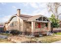 A well-maintained home with a classic brick exterior and neatly landscaped front yard at 3370 W Clyde Pl, Denver, CO 80211