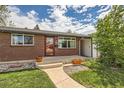 Inviting front porch area with red brick, leading to a modern home with nice landscaping at 2986 W Union Ave, Englewood, CO 80110
