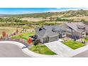 Stunning aerial view of home showcasing professional landscaping and a scenic backdrop with surrounding greenery at 15773 Timber Trek Way, Monument, CO 80132