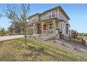 Charming two-story home with well-maintained lawn and stone details on the facade at 26731 E Hinsdale Pl, Aurora, CO 80016