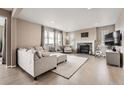 Bright and airy living room with a cozy fireplace and plush furnishings at 26731 E Hinsdale Pl, Aurora, CO 80016