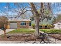 Charming home featuring a well-maintained front yard, brick accents, and mature tree at 845 S Kenton St, Aurora, CO 80012
