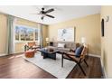 Cozy living room filled with natural light, featuring a large window and neutral color palette at 845 S Kenton St, Aurora, CO 80012