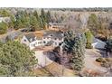 Aerial view of a home showcasing its mature trees, landscaping, and white exterior at 1 Random Rd, Englewood, CO 80113