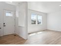 Bright living room with new flooring, fresh white paint, and abundant natural light at 691 N Tempe St, Aurora, CO 80018