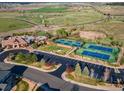 Aerial view of community clubhouse, tennis courts, green space, and parking at 6738 Esmeralda Dr, Castle Rock, CO 80108