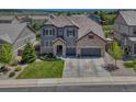 Expansive aerial view of a gray home showcasing its landscaping, large yard, and neighborhood at 6738 Esmeralda Dr, Castle Rock, CO 80108
