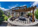 Enjoy outdoor living in this backyard with a custom stone patio, pergola, and landscaped garden at 6738 Esmeralda Dr, Castle Rock, CO 80108