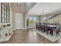 Inviting dining room with hardwood floors, a modern chandelier, and lots of natural light at 6738 Esmeralda Dr, Castle Rock, CO 80108