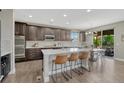 Gourmet kitchen featuring a large center island with seating, stainless steel appliances and granite countertops at 6738 Esmeralda Dr, Castle Rock, CO 80108