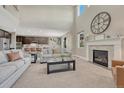 Bright living room with a fireplace, soaring ceilings, neutral carpet, and large windows at 6738 Esmeralda Dr, Castle Rock, CO 80108