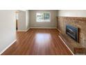 Inviting living room with hardwood floors, brick fireplace, and natural light at 13235 Rigel Dr, Lone Tree, CO 80124