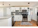Well-lit kitchen features stainless steel appliances and granite countertops at 3216 N Saint Paul St, Denver, CO 80205