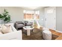 Stylish living room with hardwood floors, comfortable seating, and a bright window, creating a welcoming space at 3216 N Saint Paul St, Denver, CO 80205