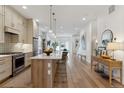 Spacious kitchen featuring a large island, modern lighting, and stainless steel appliances at 2840 S Bannock St, Englewood, CO 80110