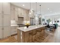 Elegant kitchen with island seating, pendant lights, and modern stainless steel appliances at 2840 S Bannock St, Englewood, CO 80110