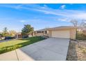 Well-maintained single-story home with a spacious driveway and attached two-car garage at 772 Urban Ct, Lakewood, CO 80401