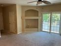 Neutral living room with a ceiling fan, a sliding glass door to a balcony, and a decorative alcove at 5255 Memphis St # 712, Denver, CO 80239