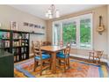Dining room with large window, wooden table with blue cushioned chairs, and colorful rug at 1160 S Sherman St, Denver, CO 80210
