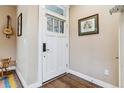 Entryway features a white door with glass panel, hardwood floors, and stylish decor at 1160 S Sherman St, Denver, CO 80210