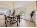 Elegant dining area with a modern chandelier and access to the outdoor space at 2101 Champlain Dr, Boulder, CO 80301