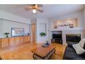 Bright living room with a fireplace, built-in cabinets, and hardwood floors at 10132 Nickolas Ave, Highlands Ranch, CO 80130