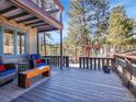 Inviting outdoor deck area with comfortable seating perfect for relaxing and enjoying nature at 3817 Ponderosa Dr, Evergreen, CO 80439