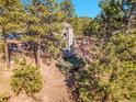 Wood home exterior showcasing a wrap around deck, ideal for enjoying the peaceful and serene outdoor space at 3817 Ponderosa Dr, Evergreen, CO 80439