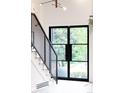 Bright entryway featuring steel staircase and abundant natural light through a large window at 10000 E Ohio Ave, Denver, CO 80247