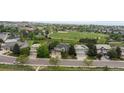 An aerial view shows the roof and surrounding community and greenery, with a baseball field nearby at 9453 Lark Sparrow Dr, Highlands Ranch, CO 80126