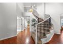 Foyer features wood flooring, curved staircase with iron railings, and a statement chandelier at 9453 Lark Sparrow Dr, Highlands Ranch, CO 80126