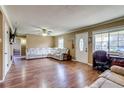 Bright living room with wood floors, white leather sofa and lots of natural light at 1881 E 95Th Ave, Thornton, CO 80229