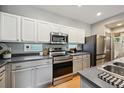 Modern kitchen with stainless steel appliances and gray countertops at 2813 Central Park Blvd, Denver, CO 80238