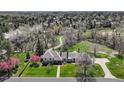 A grand home and grounds set in a scenic, wooded neighborhood at 21 Huntwick Ln, Cherry Hills Village, CO 80113