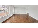Bright living room with refinished hardwood floors; features updated paint and lots of natural light at 3212 Uvalda St, Aurora, CO 80011