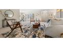 Charming living room featuring seamless flow into the adjacent dining room at 3942 E Evans Ave, Denver, CO 80210