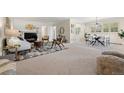 Spacious living room flowing into dining area with natural light at 3942 E Evans Ave, Denver, CO 80210
